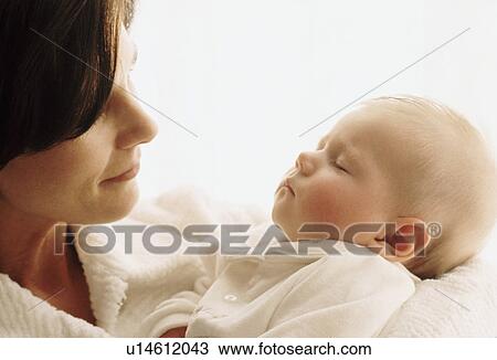 Stock Image - Mother holding her sleeping baby. Fotosearch