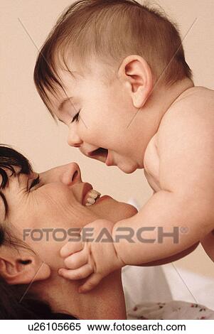 Stock Photography - Mother playing with her baby. Fotosearch