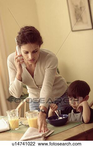 Stock Image - Multi tasking mother. Fotosearch