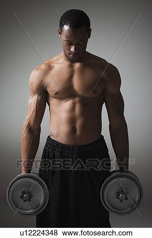 Muscular man lifting dumbbells View Large Photo Image Stock Photo - Muscular man lifting dumbbells. Fotosearch