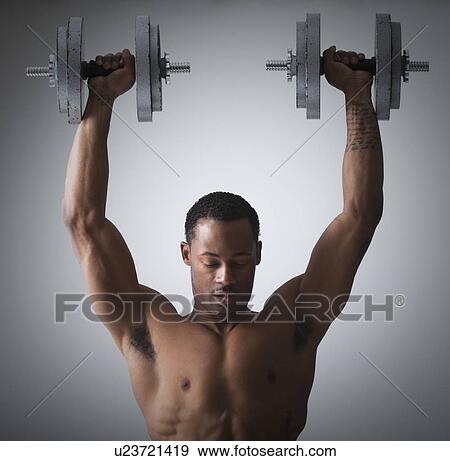 Muscular man lifting dumbbells View Large Photo Image Stock Photo - Muscular man lifting dumbbells. Fotosearch