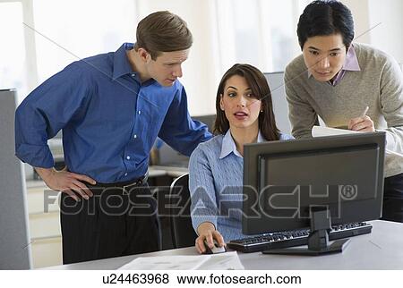 Stock Photo - Office workers in cubicle. Fotosearch