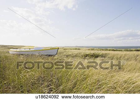 Stock Image - Old wooden boat in the grass. Fotosearch