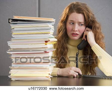 Overworked woman in cubicle View Large Photo Image Stock Image - Overworked woman in cubicle. Fotosearch