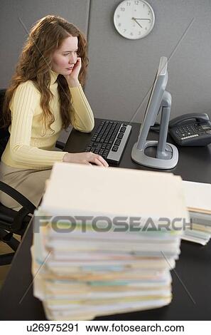 Overworked woman in cubicle View Large Photo Image Stock Image - Overworked woman in cubicle. Fotosearch