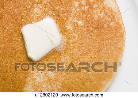 Stock Image - Pancake and butter on plate. Fotosearch