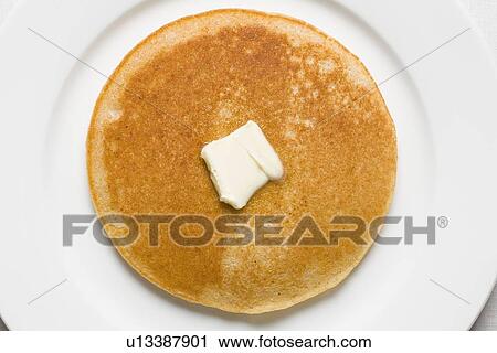 Stock Image - Pancake and butter on plate. Fotosearch