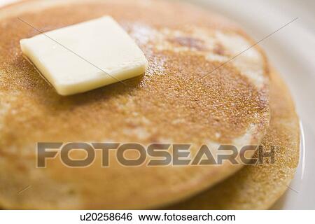 Stock Photograph - Pancakes and butter on plate. Fotosearch