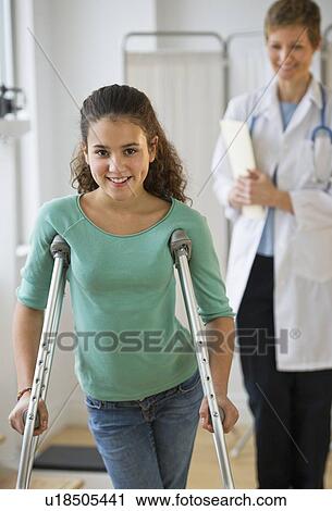Stock Image - Patient walking on crutches. Fotosearch