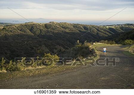 Person running on trail View Large Photo Image Stock Photo - Person running on trail. Fotosearch