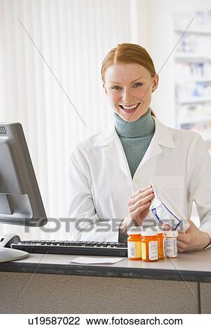 Pharmacist holding prescription medication View Large Photo Image Stock Image - Pharmacist holding prescription medication. Fotosearch