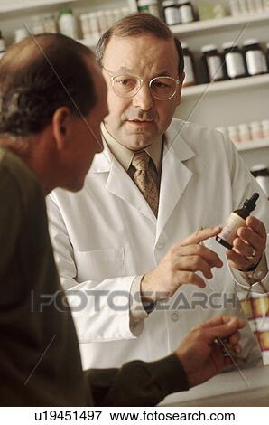 Stock Photo - Pharmacist talking to customer. Fotosearch