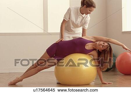 Physical therapist helping a patient View Large Photo Image Stock Photography - Physical therapist helping a patient. Fotosearch