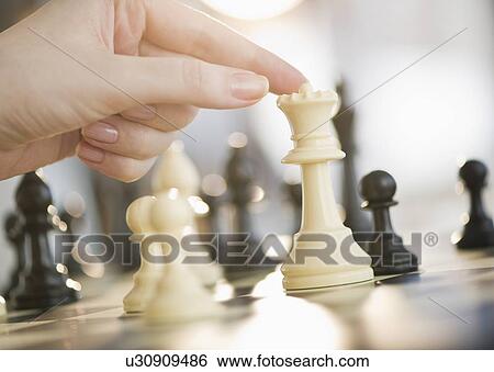 Stock Photograph - Playing game of chess. Fotosearch