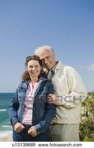 Portrait of a couple by the beach View Large Photo Image Stock Photo - Portrait of a couple by the beach. Fotosearch