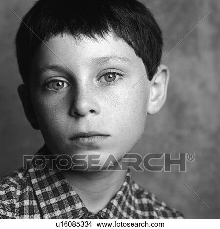 Picture - Portrait of a serious young boy. Fotosearch
