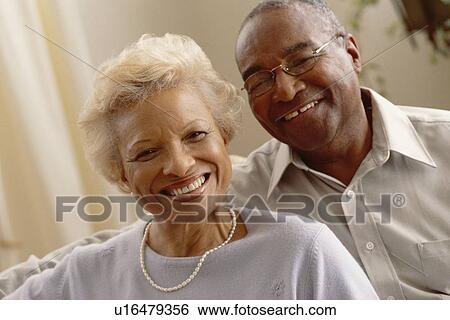Stock Photograph - Portrait of a smiling elderly couple. Fotosearch