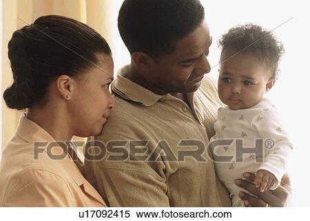 Portrait of parents with their baby View Large Photo Image Stock Photography - Portrait of parents with their baby. Fotosearch
