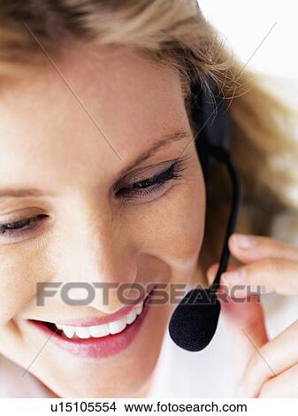 Picture - Receptionist wearing headset. Fotosearch