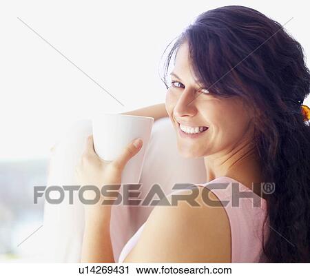 Relaxed woman drinking coffee View Large Photo Image Stock Image - Relaxed woman drinking coffee. Fotosearch