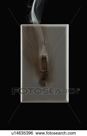 Stock Photograph - Smoke emanating from an electrical switch. Fotosearch