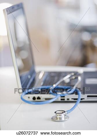 Stock Photo - Stethoscope on laptop. Fotosearch