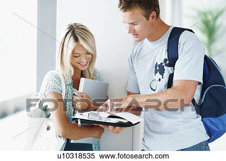 Students looking at book together View Large Photo Image Stock Photography - Students looking at book together. Fotosearch