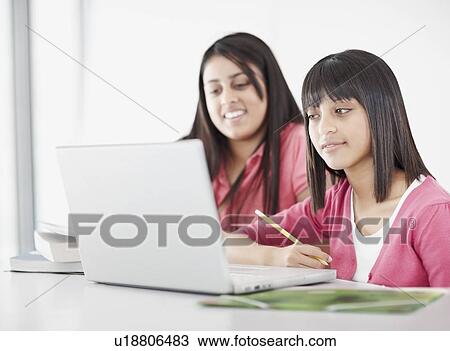 Students working on laptops in classroom View Large Photo Image Stock Image - Students working on laptops in classroom. Fotosearch