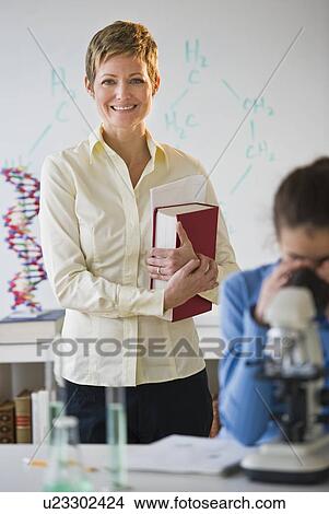 Picture - Teacher and student in science lab. Fotosearch