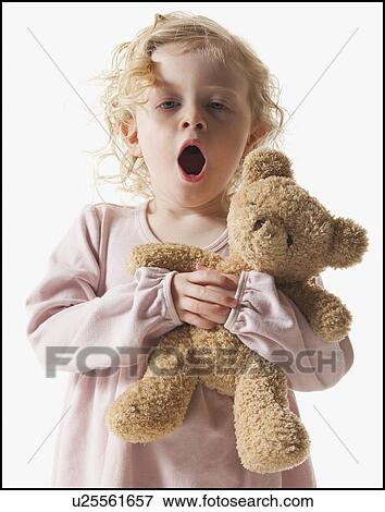 Tired young girl holding teddy bear View Large Photo Image Stock Photo - Tired young girl holding teddy bear. Fotosearch