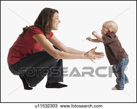 Stock Image - Toddler learning to walk. Fotosearch