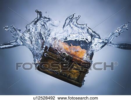 Stock Image - Treasure chest sinking in water. Fotosearch