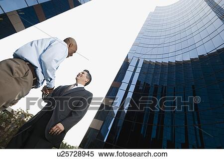 Stock Photography - Two businessmen shaking hands. Fotosearch