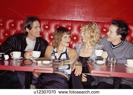 Two young couples at a restaurant View Large Photo Image Stock Image - Two young couples at a restaurant. Fotosearch