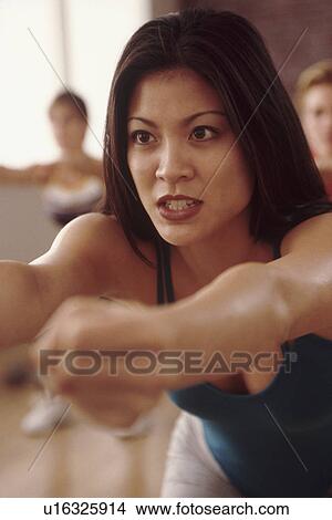 Picture - Woman at an exercise class. Fotosearch