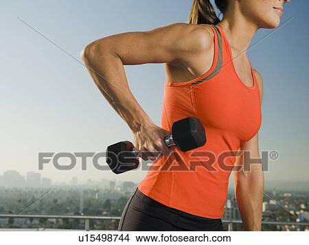 Woman doing weight training View Large Photo Image Picture - Woman doing weight training. Fotosearch