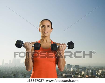 Woman doing weight training View Large Photo Image Stock Photo - Woman doing weight training. Fotosearch