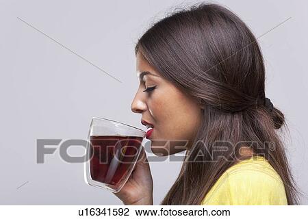 Stock Image - Woman drinking tea. Fotosearch