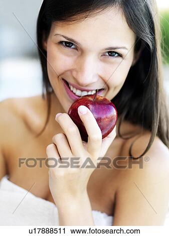 Stock Image - Woman eating an apple. Fotosearch