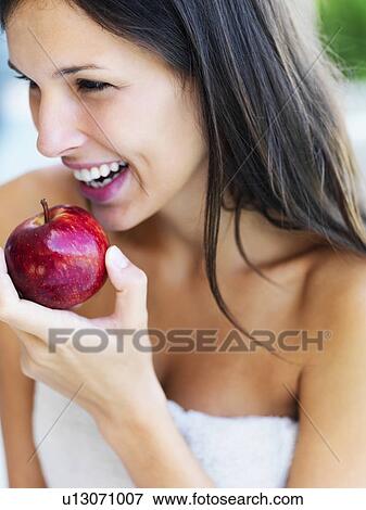 Stock Photo - Woman eating an apple. Fotosearch
