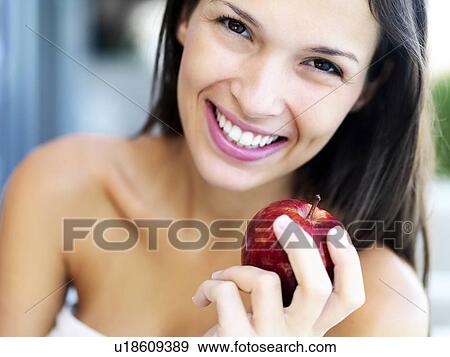 Stock Photo - Woman eating an apple. Fotosearch
