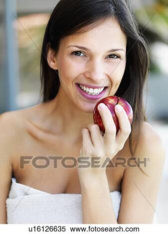 Stock Photography - Woman eating an apple. Fotosearch