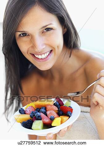 Woman eating fresh fruit View Large Photo Image Stock Image - Woman eating fresh fruit. Fotosearch