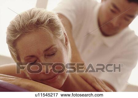 Stock Photo - Woman enjoying a massage. Fotosearch