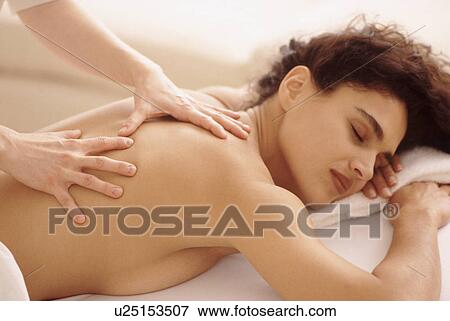 Stock Photo - Woman enjoying a massage. Fotosearch