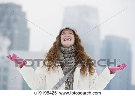 Stock Photography - Woman enjoying a snowy day. Fotosearch