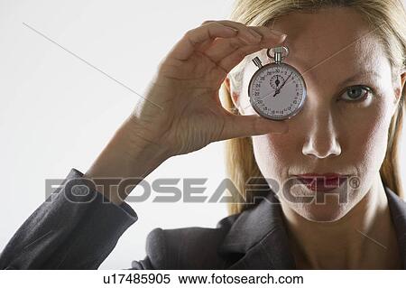 Stock Photography - Woman holding a stopwatch. Fotosearch