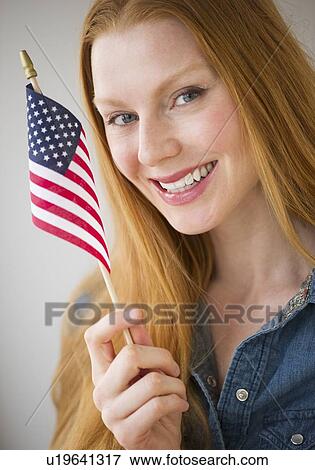 Woman holding American flag View Large Photo Image Stock Photo - Woman holding American flag. Fotosearch