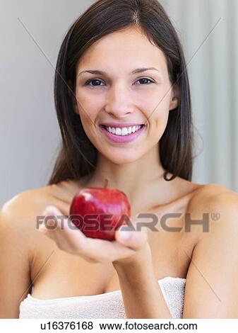 Stock Photo - Woman holding an apple. Fotosearch