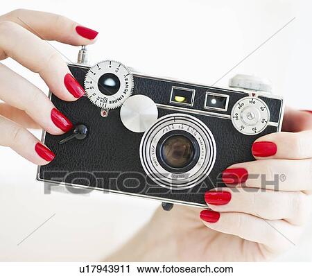 Woman holding antique camera View Large Photo Image Stock Image - Woman holding antique camera. Fotosearch